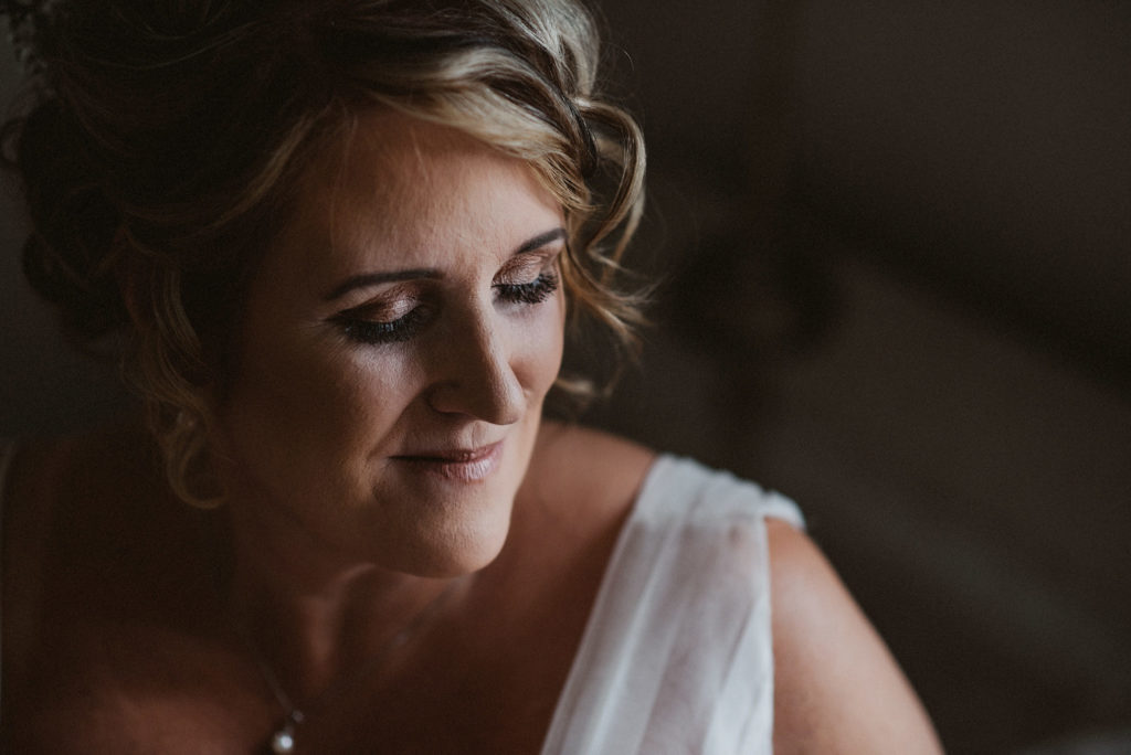 Portrait of a bride looking down serenely at Ashfield House