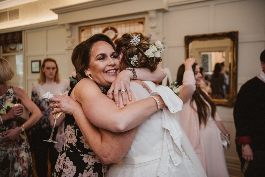 Wedding guest hugs bride after the wedding ceremony at Ashfield House
