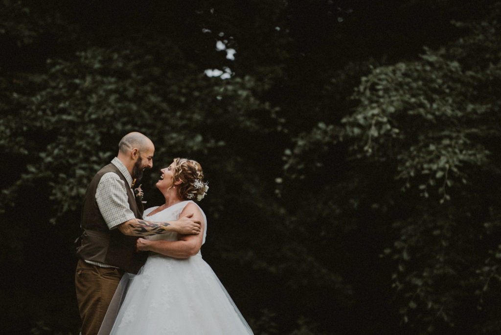 Bride and groom hold each other and look into each other's eyes at Ashfield House