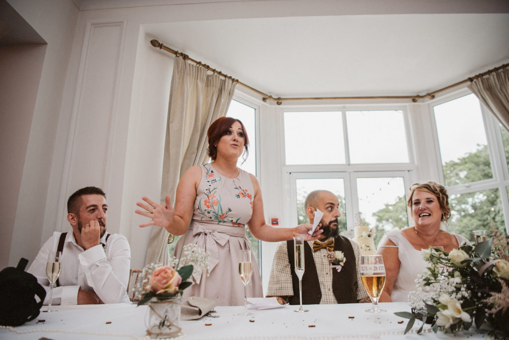 The bride's daughter tells a joke during the wedding speeches at Ashfield House
