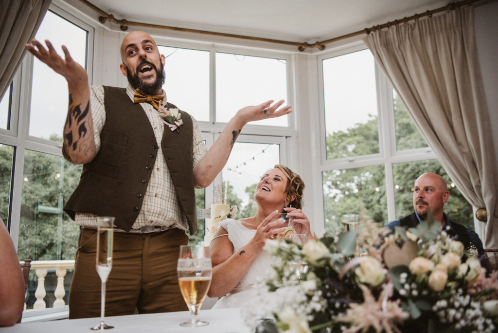 The groom tells a joke during his speech at his wedding