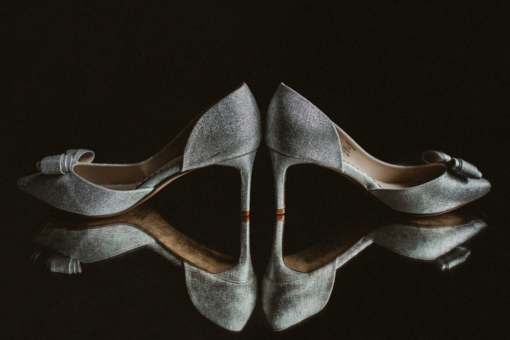 Silver bridal shoes sitting on table