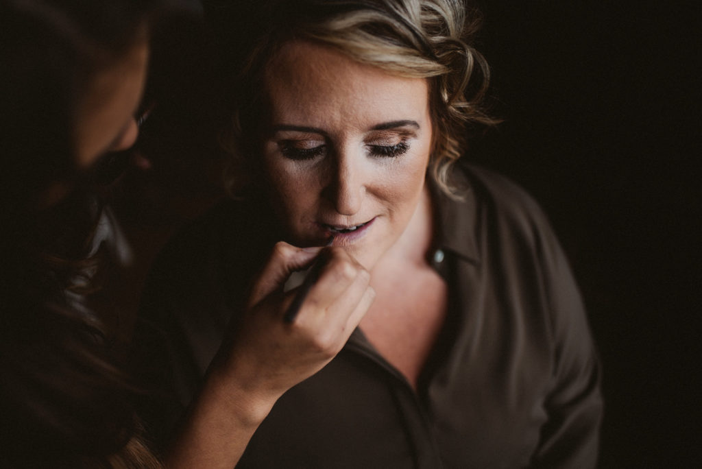 Bride having lipstick applied at Ashfield House