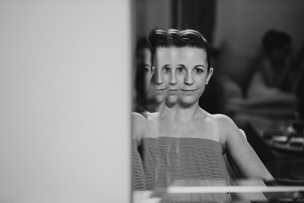 bride looks into mirror at Easton Grange