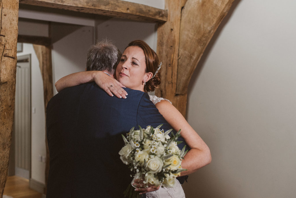 bride hugs her father at Easton Grange