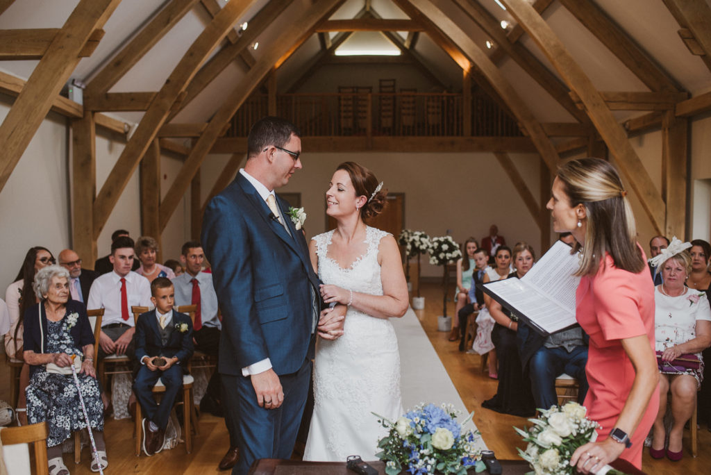 bride and groom look into each others eyes during their Surrey relaxed barn wedding ceremony