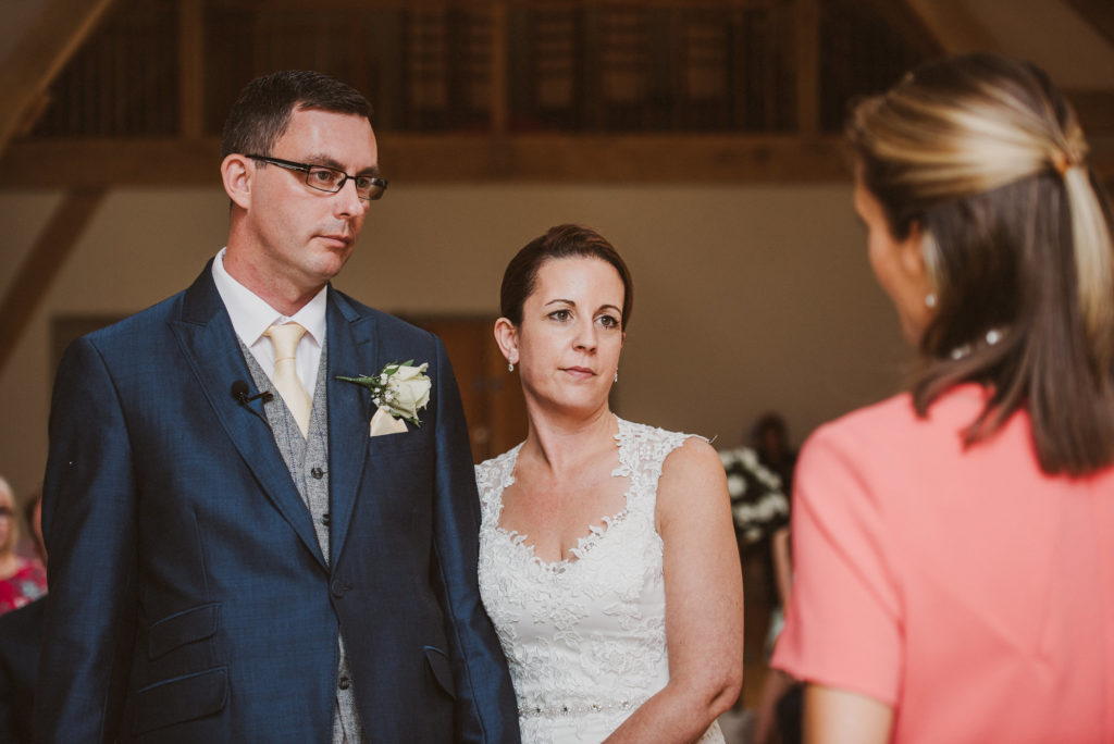 Surrey bride and groom look at the celebrant during their wedding ceremony