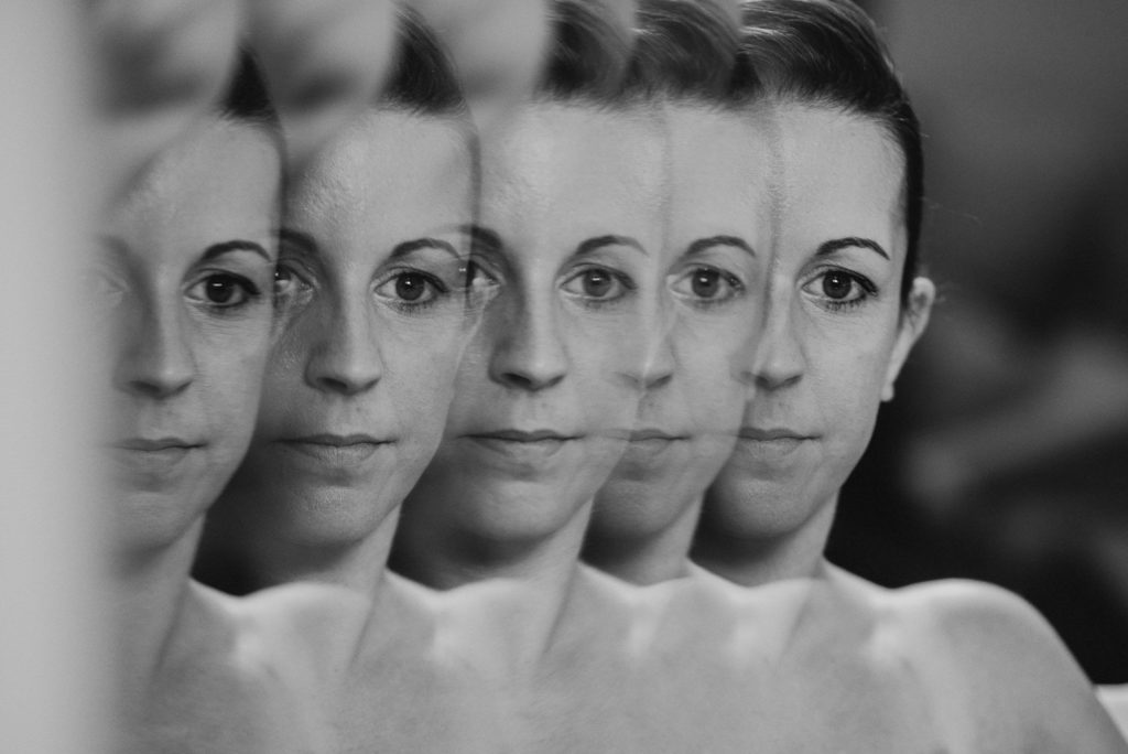 creative photograph of bride looking into mirror