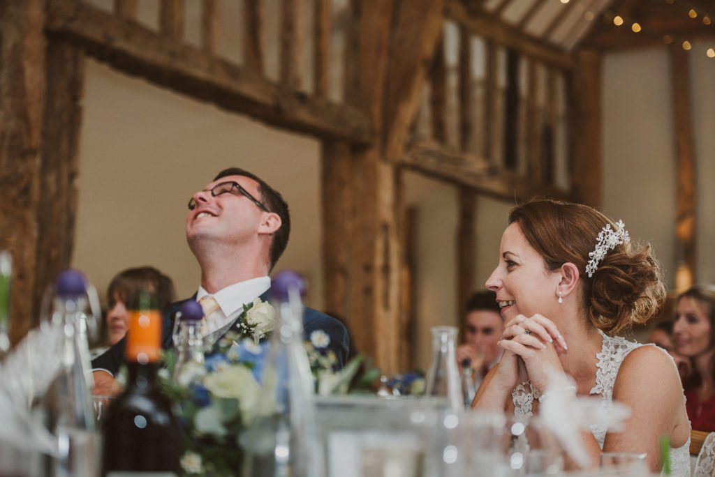 bride and groom laugh during wedding breakfast speeches in the Celebration Barn