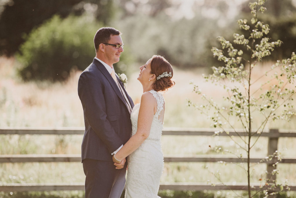 bride and groom look at each other during golden hour