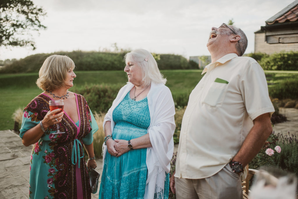 wedding guests laugh and talk in Woodbridge