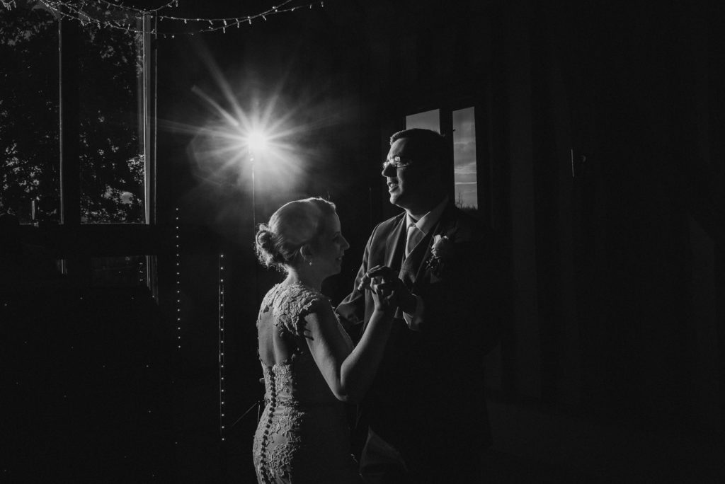 creative photograph of bride and groom during their first dance at a farm