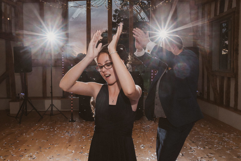 bridesmaid clapping and dancing during a wedding reception