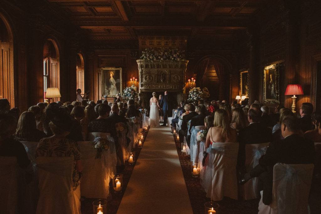 bride and groom at the end of the aisle during their wedding ceremony in the Great Hall at Cliveden House