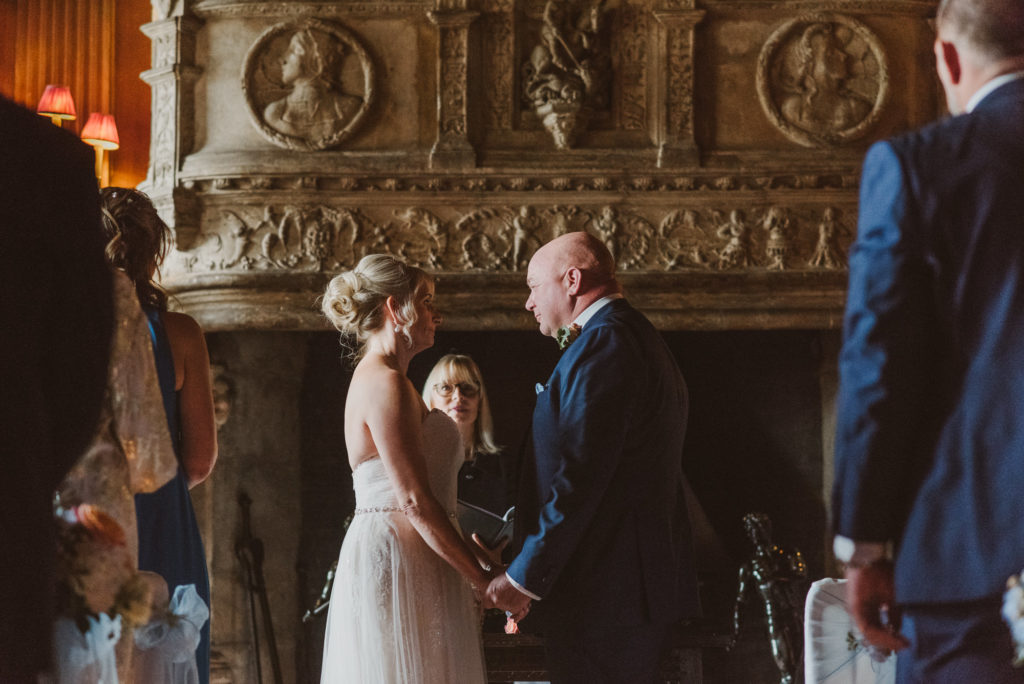 bride and groom face each other and say vows to each other during their wedding ceremony at Cliveden House