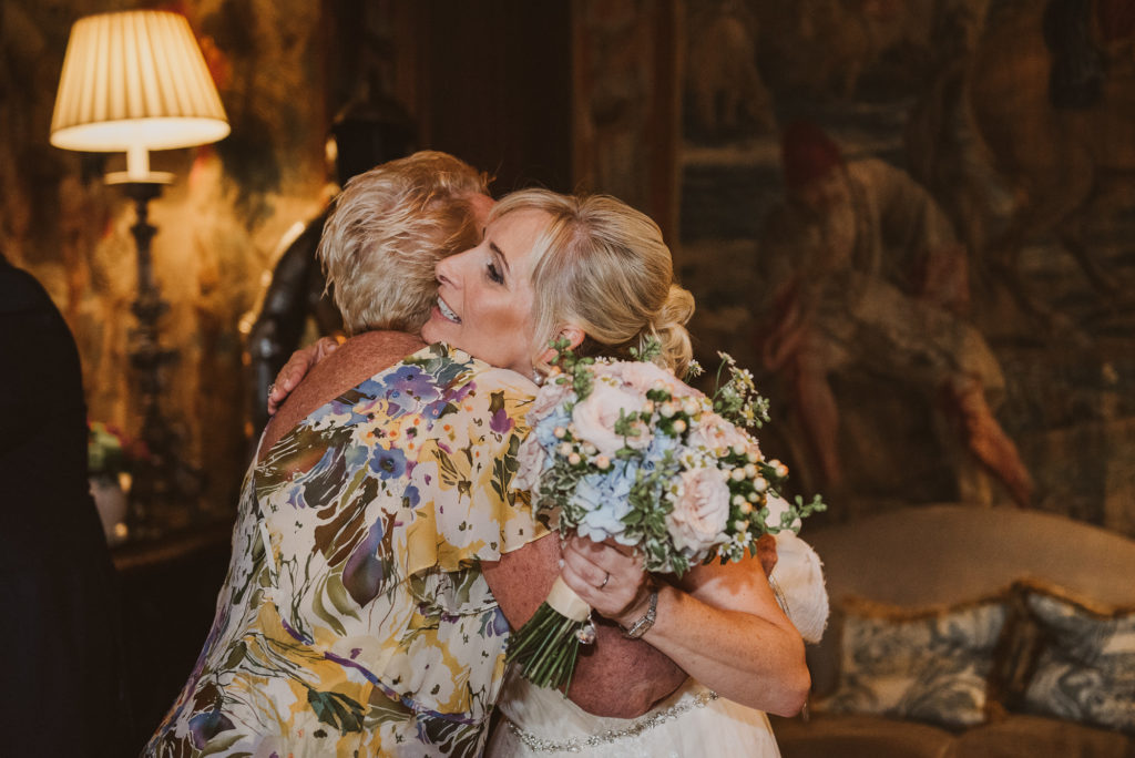 bride hugs her wedding guest after her wedding ceremony