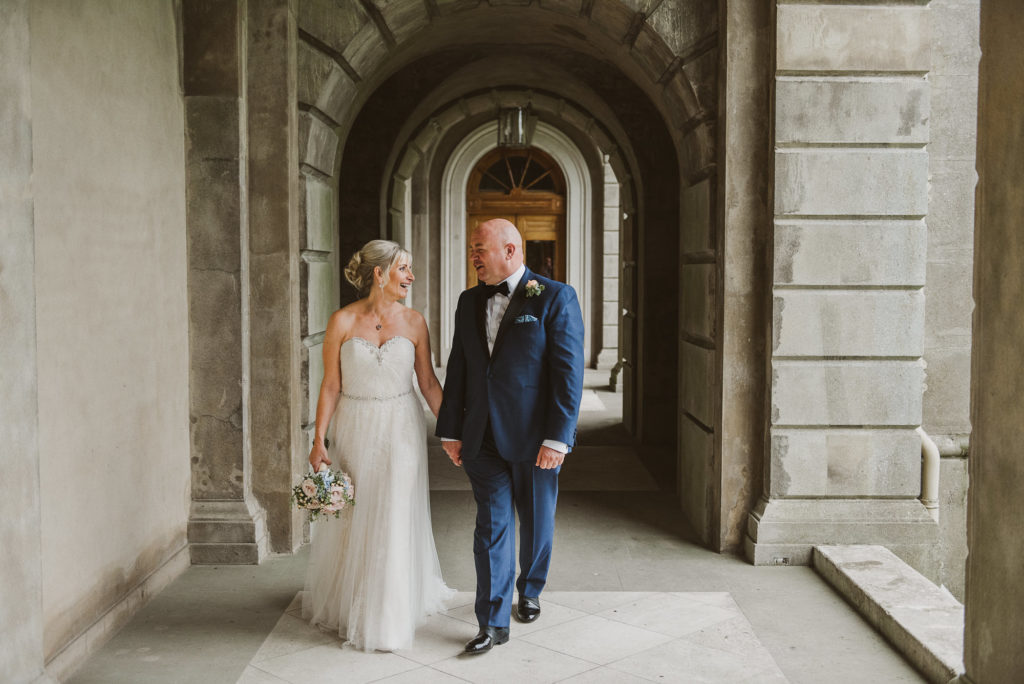 bride and groom hold hands and walk along in Berkshire