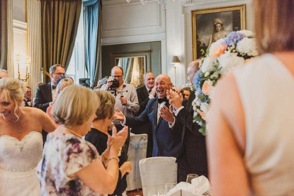 the groom looks happy as he enters the French Dining Room at Cliveden