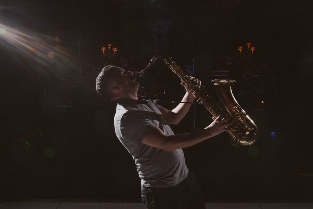 a man plays a saxophone during a wedding reception