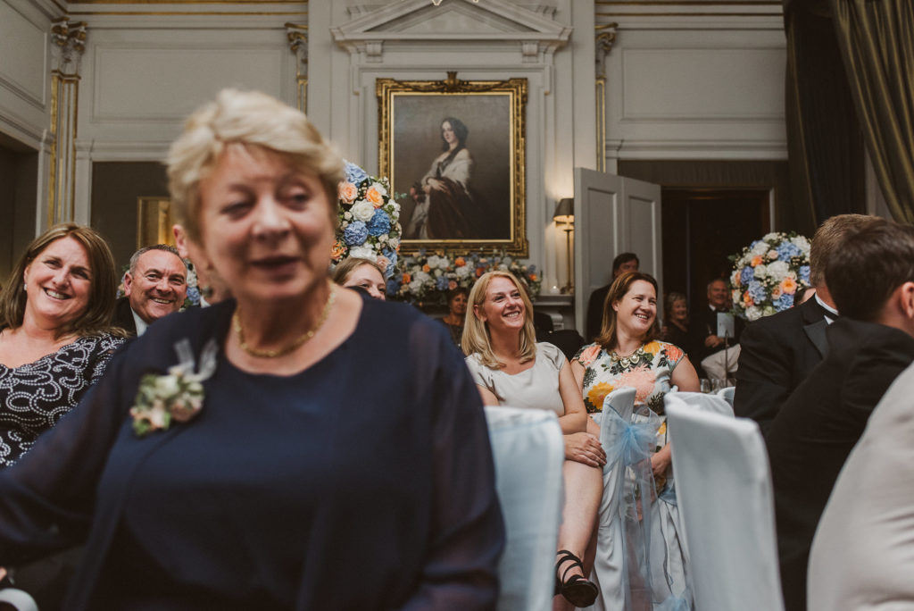 wedding guests laugh during the speeches in the French Dining Room