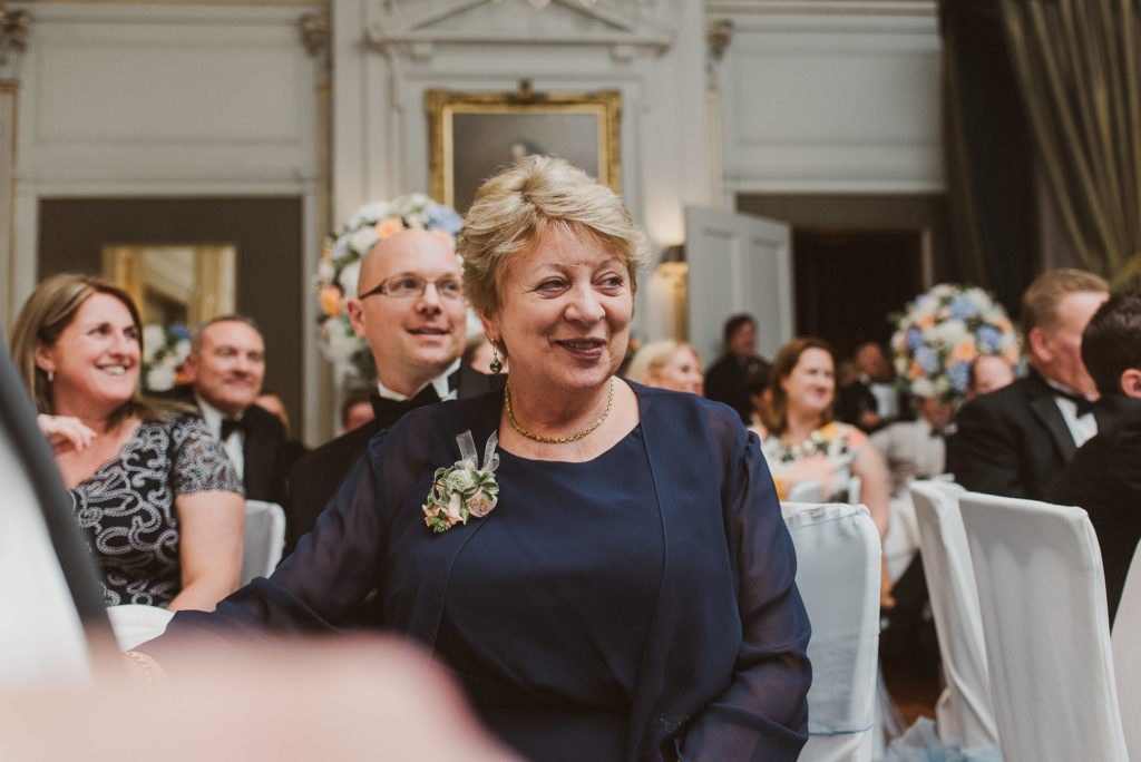 a lady reacts to a funny speech with joy in the French Dining Room at Cliveden