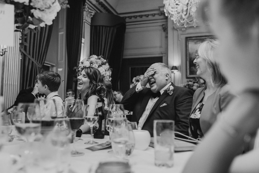 a groomsman looks embarrassed during the groom's speech in the French Dining Room