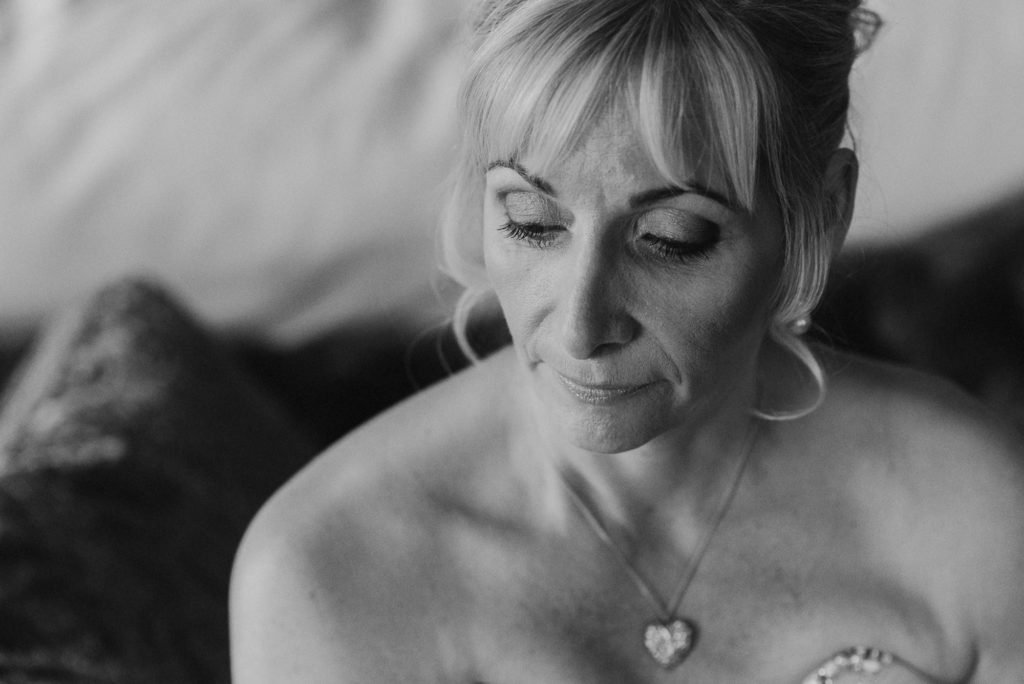 bride looks down serenely in bridal portrait in the Lady Astor Suite