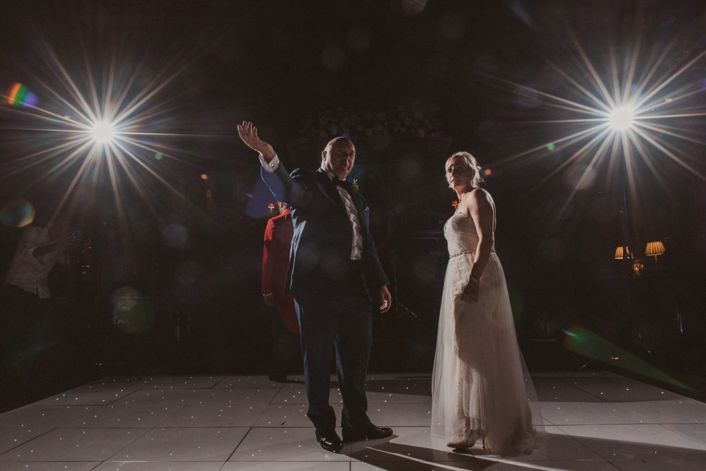 groom welcomes his guests onto the dancefloor during the first dance in the Great Hall