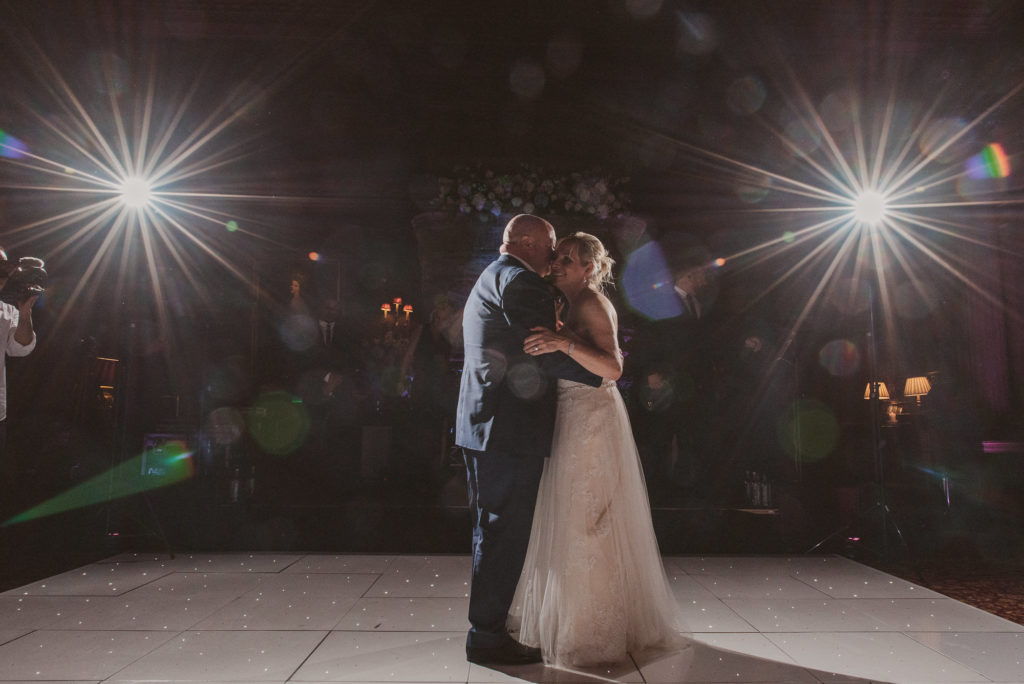 bride and groom hold each other during their first dance in the Great Hall