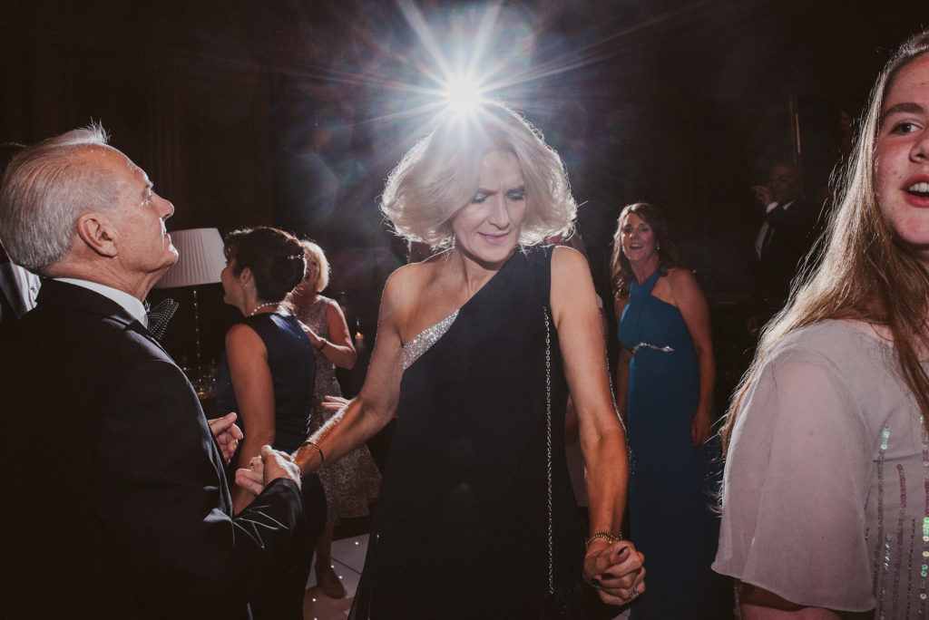 a wedding guest dances in front of a bright light in the Great Hall