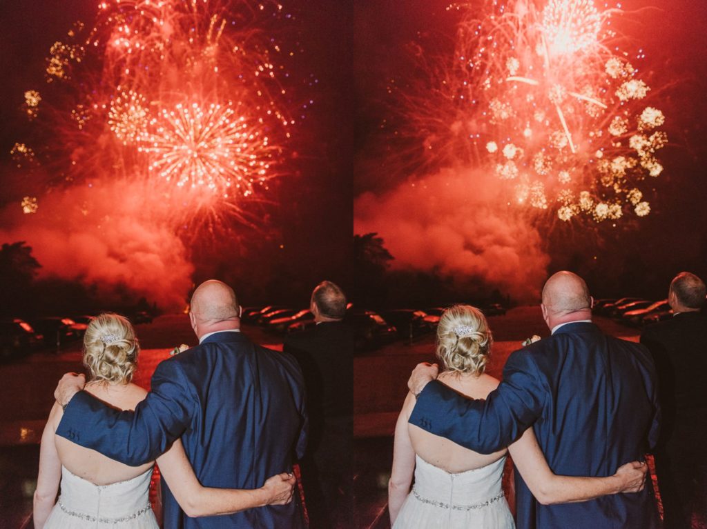 bride and groom look out at the fireworks in the carpark at Cliveden House