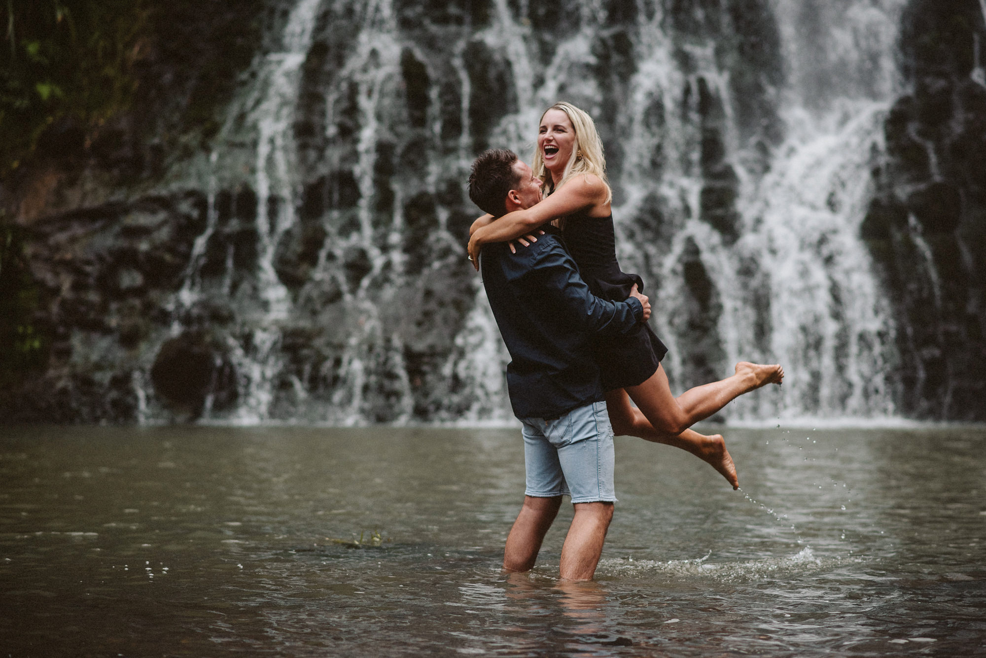 A couple have fun together in the water at Karekare Falls in West Auckland